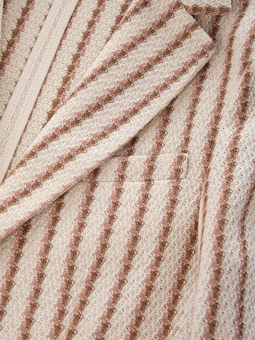 Close-up of the Circolo 1901 Slim Striped Long Jacket in Naturale Knitted, showcasing its textured fabric with beige and brown vertical stripes, notch lapel, and welt pocket.
