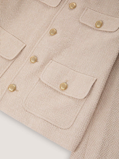 Close-up of the Circolo 1901 Cropped 4-Pocket Jacket in Linen Bistretch, a beige jacket with multiple front pockets and shiny gold metal buttons.