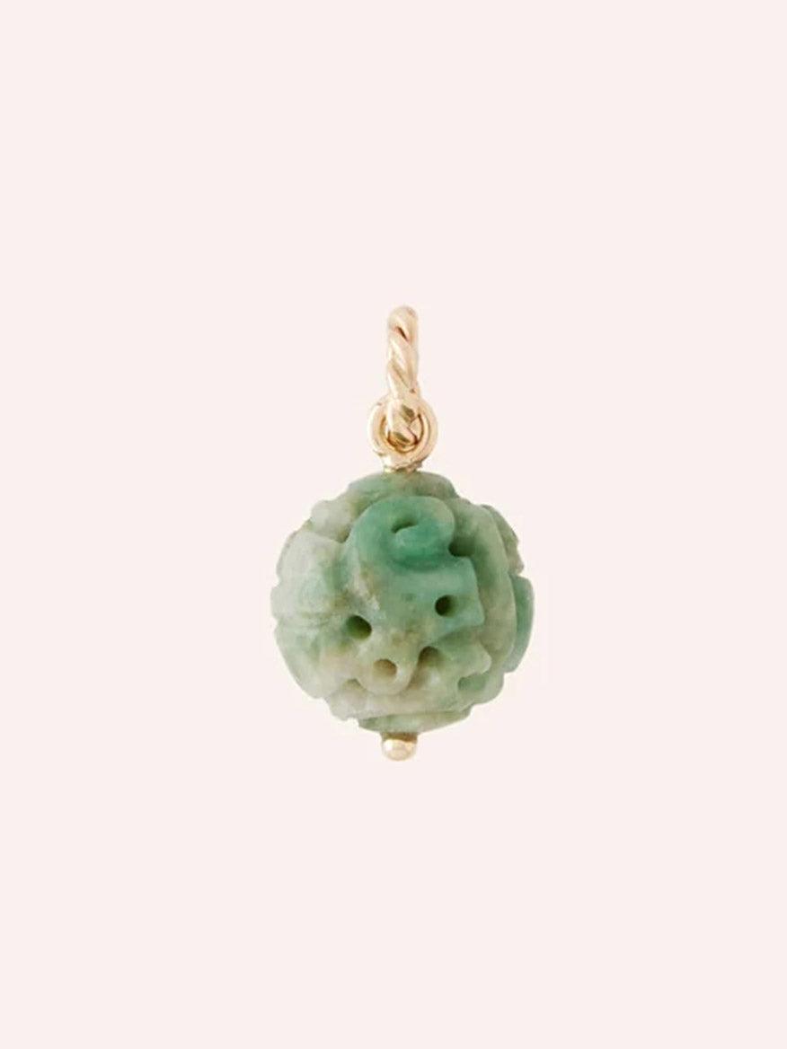 The Clara Williams 14K Green Jade Carved Charm, featuring an intricately carved green-white jade bead attached to a petite 14K yellow gold loop—perfect as a pendant or charm—is displayed against a plain light background.