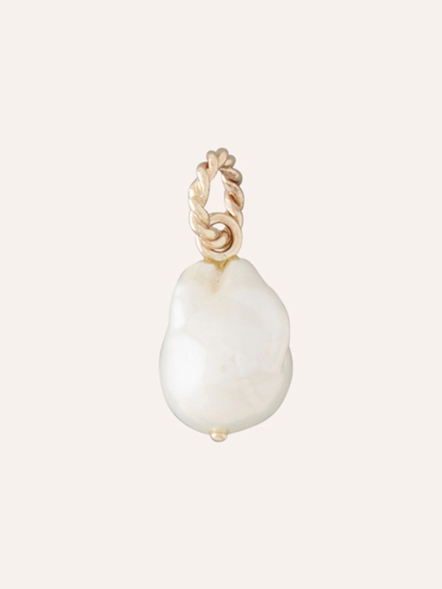 Clara Williams 14K Petite Baroque Pearl Charm featuring a single white baroque pearl pendant with a twisted rope 14K yellow gold loop, photographed on a plain light background.