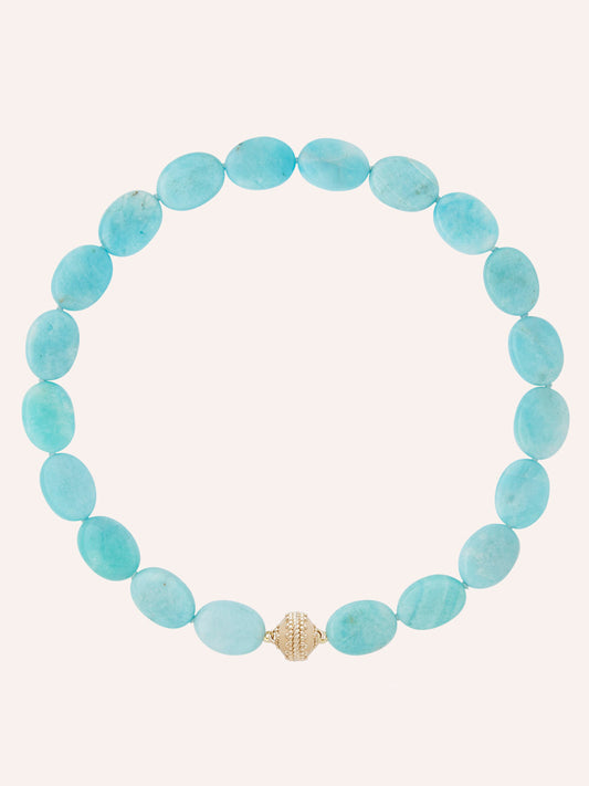 The Clara Williams Amazonite Flat Oval Necklace, featuring flat oval amazonite beads and finished with a 14K gold clasp, is arranged in a circle on a plain light background.