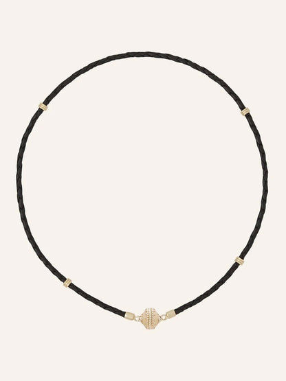 The Clara Williams Aspen Braided Leather Black Mini Necklace features a black braided leather design with gold vermeil accents and a secure sterling silver clasp, displayed on a plain light background.