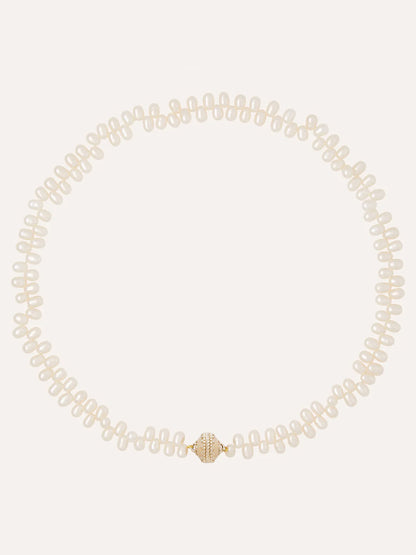 The Clara Williams Freshwater Drop Pearl Mini Necklace features evenly spaced freshwater pearls and a 14K gold clasp with a central grooved design.