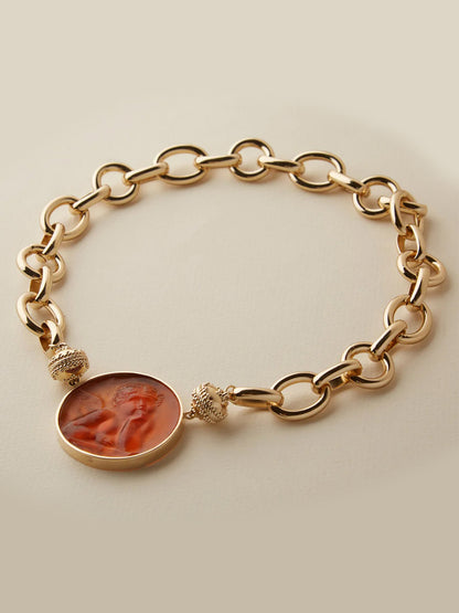 Gold chain bracelet with a sculpted profile cameo pendant, displayed on a neutral background—pairs beautifully with the Clara Williams Gold Coast Necklace for an elegant layered look.