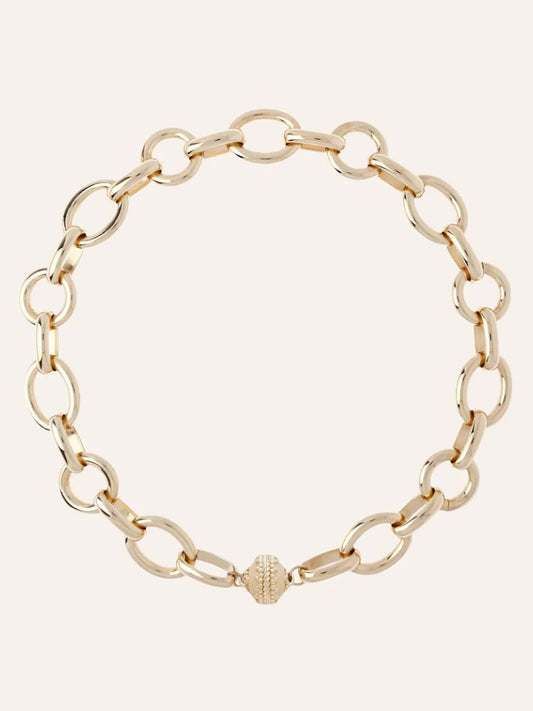 The Clara Williams Gold Coast Necklace, crafted in 14K yellow gold with large oval links and a decorative ClaraClasp, is shown on a plain background.
