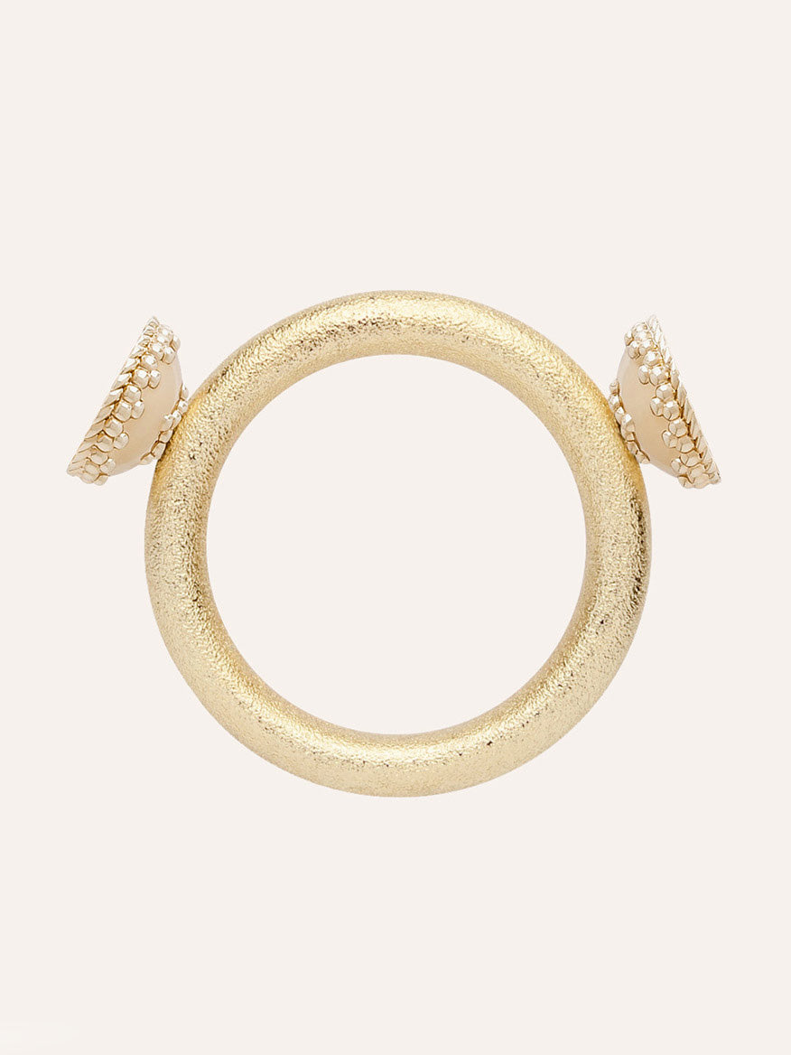 Clara Williams Halo Gold Centerpiece bracelet featuring a gold textured circular design with two white, round endcaps—each bordered by a gold beaded trim and highlighted by a subtle halo gold centerpiece—displayed on a plain light background.