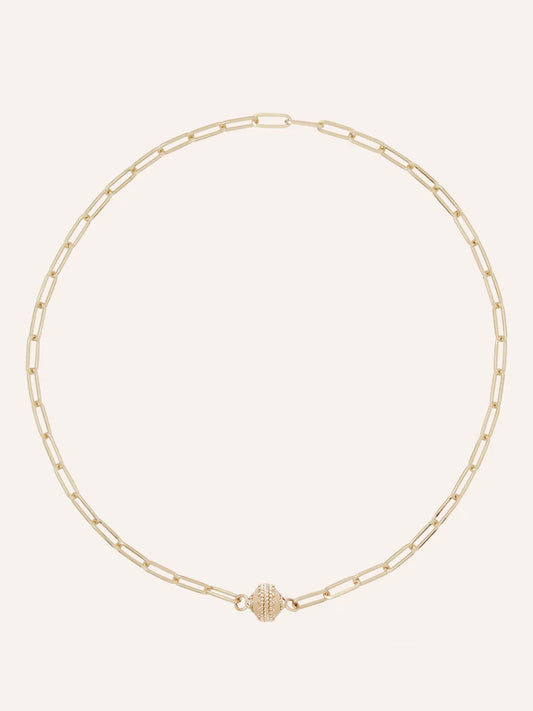 The Clara Williams Kingsbury Gold Mini Necklace features elongated 14K yellow gold paperclip links and a textured ClaraClasp centerpiece, and is displayed on a plain light background.