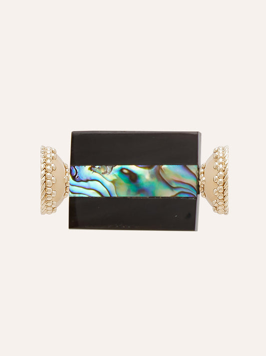 Clara Williams New Zealand Abalone Resin Geo Centerpiece features a rectangular black and iridescent abalone stone set horizontally between two decorative 14K yellow gold end caps, creating a striking focal point against a light background.