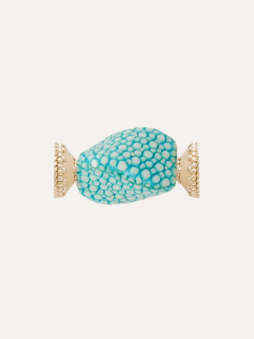 Introducing the Clara Williams Small Aquamarine Stingray Centerpiece: a stunning gold ring showcasing a textured, aquamarine blue oval centerpiece, elegantly set between two decorative 14K yellow gold ends.