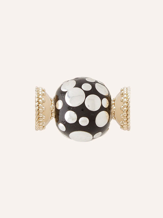Clara Williams Sterling Silver Polka Dot Centerpiece featuring a black enamel bead with white polka dots, accented by two 14K yellow gold-toned, textured end caps, set against a plain background.