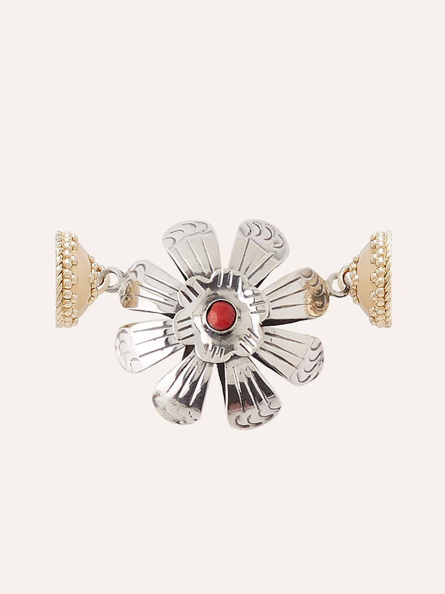 The Clara Williams Sterling Silver and Red Coral Flower Centerpiece features a flower-shaped sterling silver design with engraved petals, a striking red coral gem at the center, and intricately patterned 14K yellow gold–toned end caps.