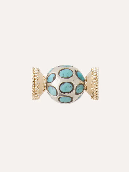 The Clara Williams Turquoise and Sterling Silver Mini Centerpiece features a spherical bead adorned with turquoise oval inlays and gold-toned, textured end caps, complemented by a sterling silver Mini Magnetic ClaraClasp and displayed against a plain background.