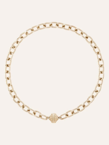 The Clara Williams Wabash Necklace, crafted in 14K yellow gold with hammered oval links and a textured ClaraClasp at the front, is displayed against a plain light background.