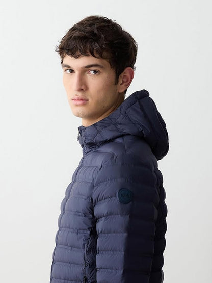 A young man wearing the Colmar Underscore Down Hooded Zip Jacket in Navy Blue/Vulcan faces sideways, looking toward the camera against a plain light background.