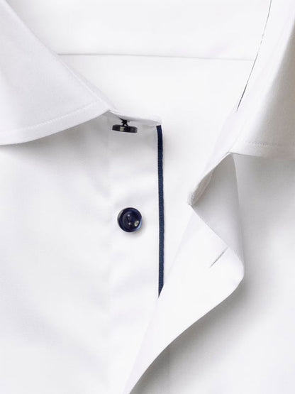 Close-up of the Eton Classic Fit Solid Signature Twill Dress Shirt in white with navy details, showcasing a white fabric, navy button, and a contrasting seam along the placket.