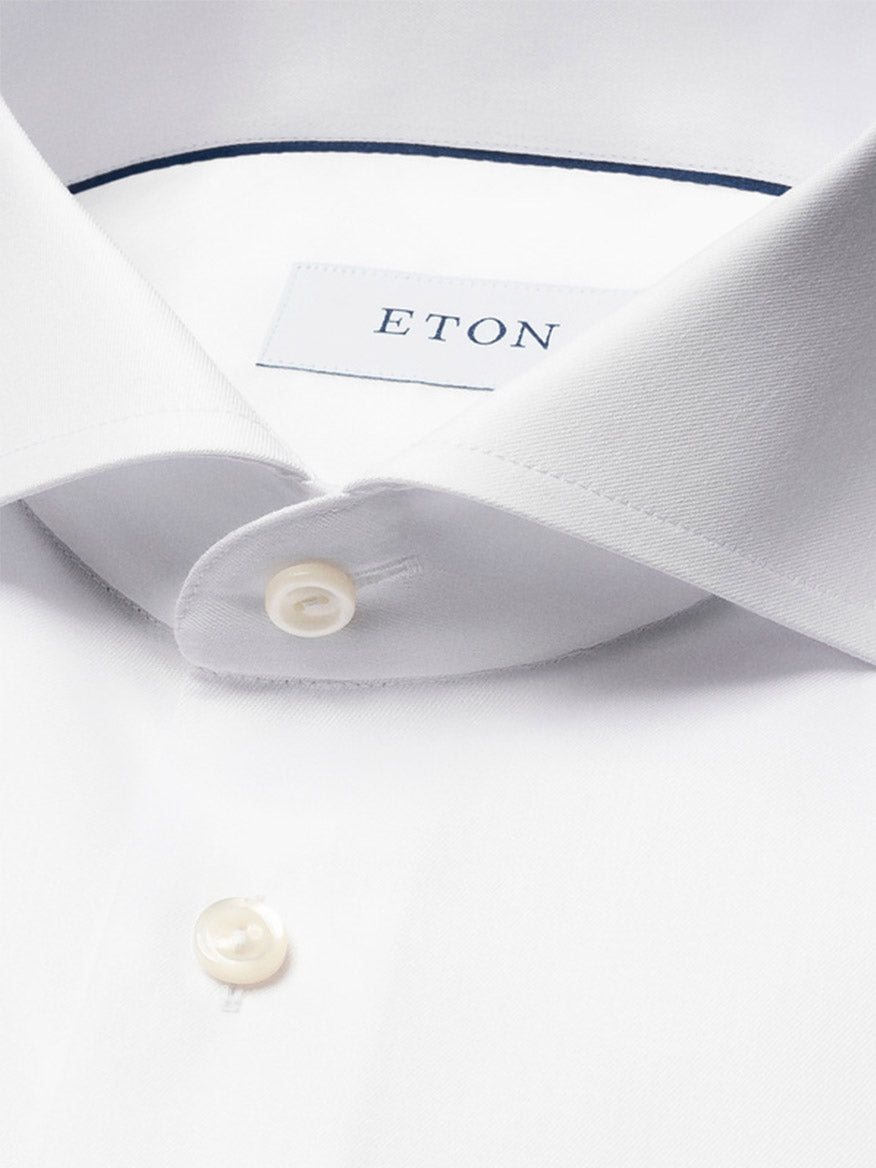 Close-up of the Eton Contemporary Fit White Extreme Cut Away Dress Shirt, featuring a spread collar, white buttons, an "ETON" collar label, and wrinkle-free Signature twill fabric.