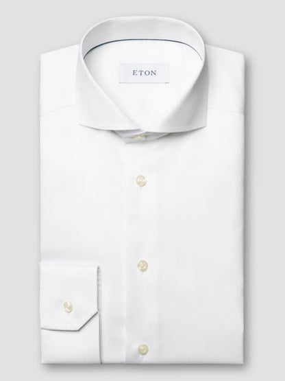 The Eton Contemporary Fit White Extreme Cut Away Dress Shirt features crisp twill fabric, an extreme cut away collar, button cuffs, and the signature Eton label inside the collar.