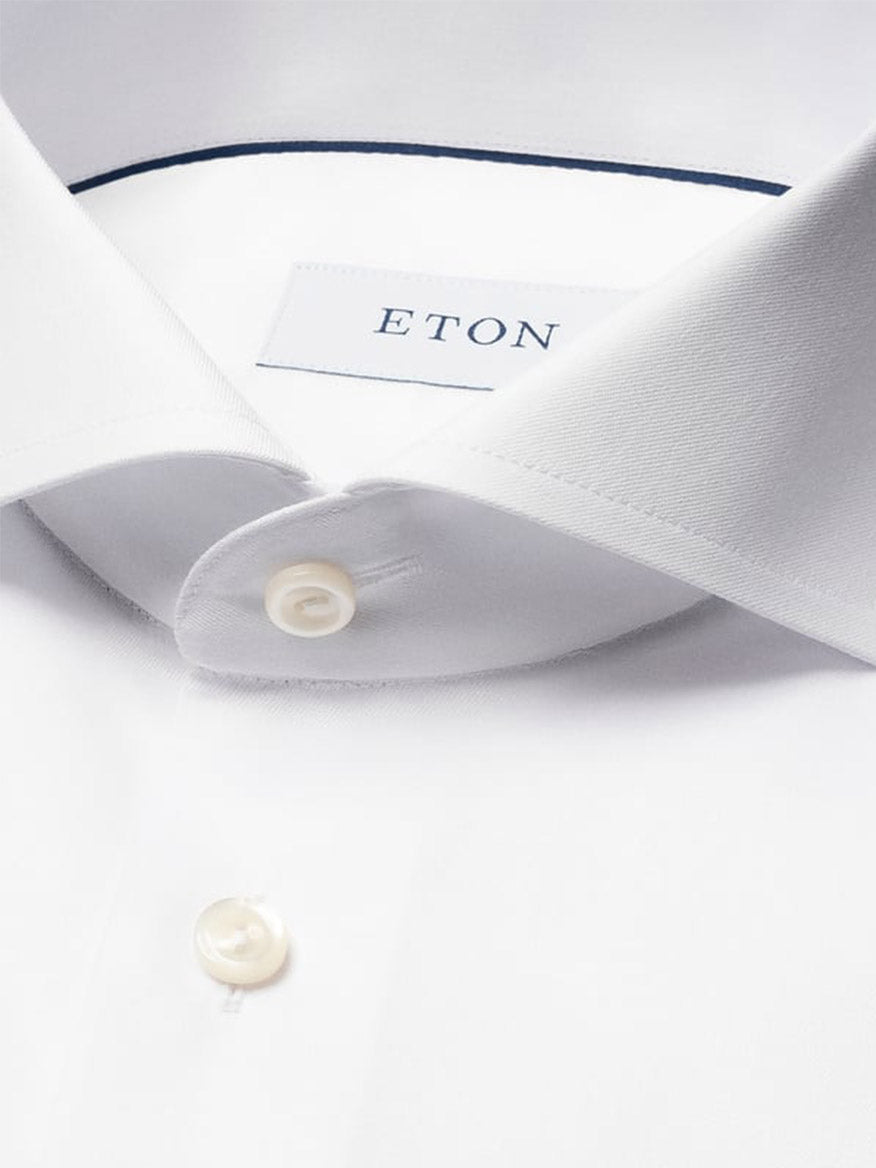 Close-up of the Eton Slim Fit Extreme Cut Away Dress Shirt in White, highlighting its pointed collar, white buttons, and an inner label marked "ETON.