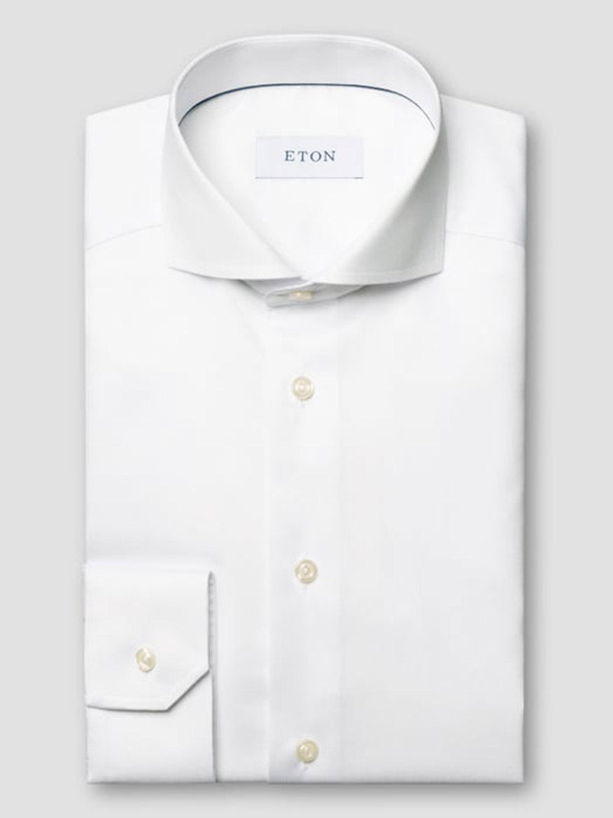 A neatly folded Eton Slim Fit Extreme Cut Away Dress Shirt in white, crafted from signature twill with a cut away collar, buttoned cuffs, and branded label inside the collar.