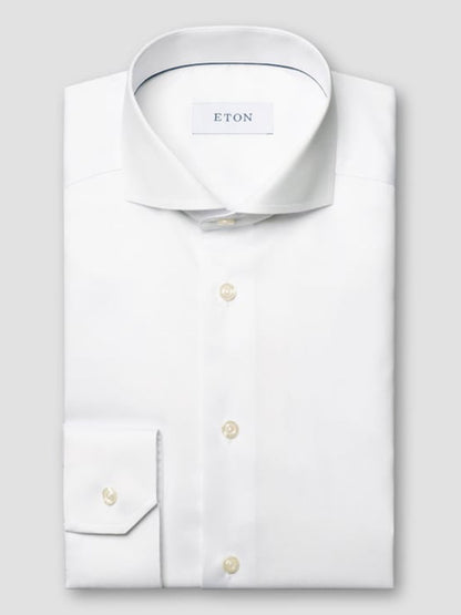 A neatly folded Eton Slim Fit Extreme Cut Away Dress Shirt in white, crafted from signature twill with a cut away collar, buttoned cuffs, and branded label inside the collar.