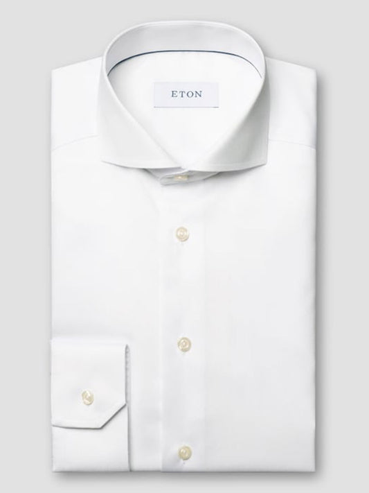 A folded Eton Slim Fit White Extreme Cut Away Dress Shirt with a brand label inside the collar is displayed against a plain gray background.