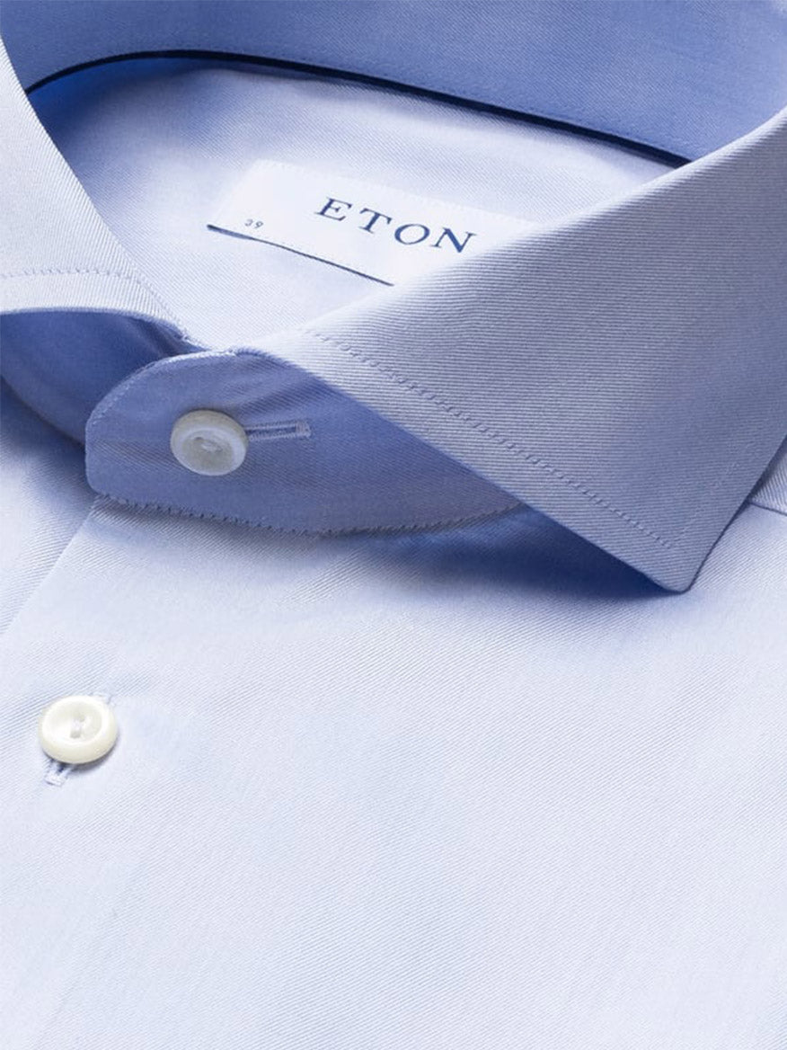 Close-up of the Eton Slim Fit Extreme Cut Away Dress Shirt in Sky Blue, made from Signature Twill organic cotton, showing detailed collar, buttons, and brand label inside the neck.