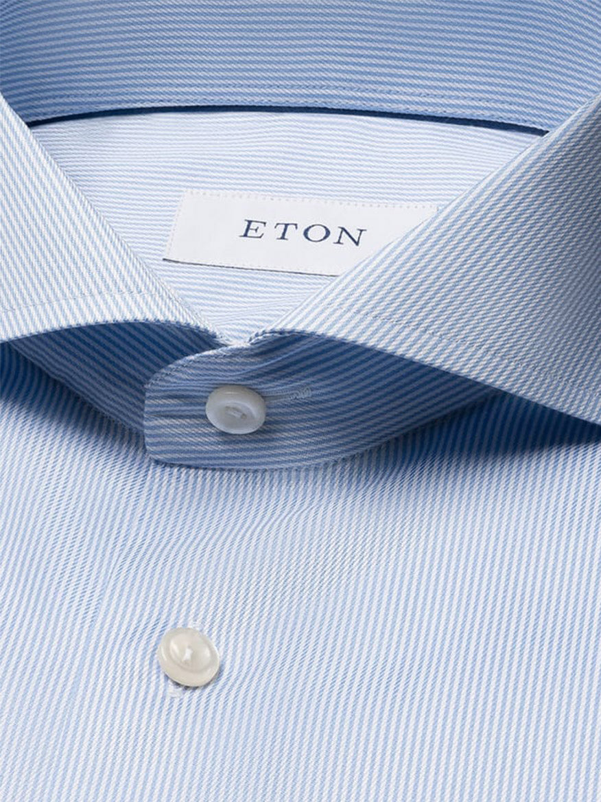 Close-up of an Eton Slim Fit Fine Striped Signature Twill Dress Shirt in light blue, featuring an extreme cut away collar and signature ETON label—a modern business staple.