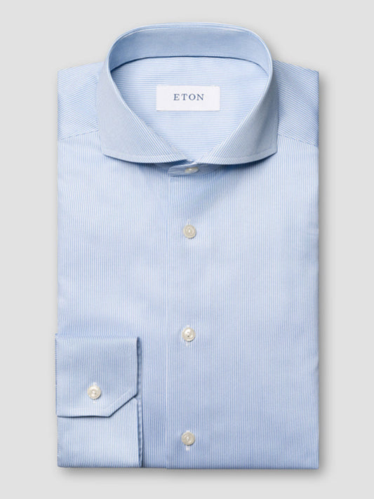 The Eton Slim Fit Fine Striped Signature Twill Dress Shirt in Light Blue features an extreme cut away collar and subtle stripes—an ideal choice for a classic business look.