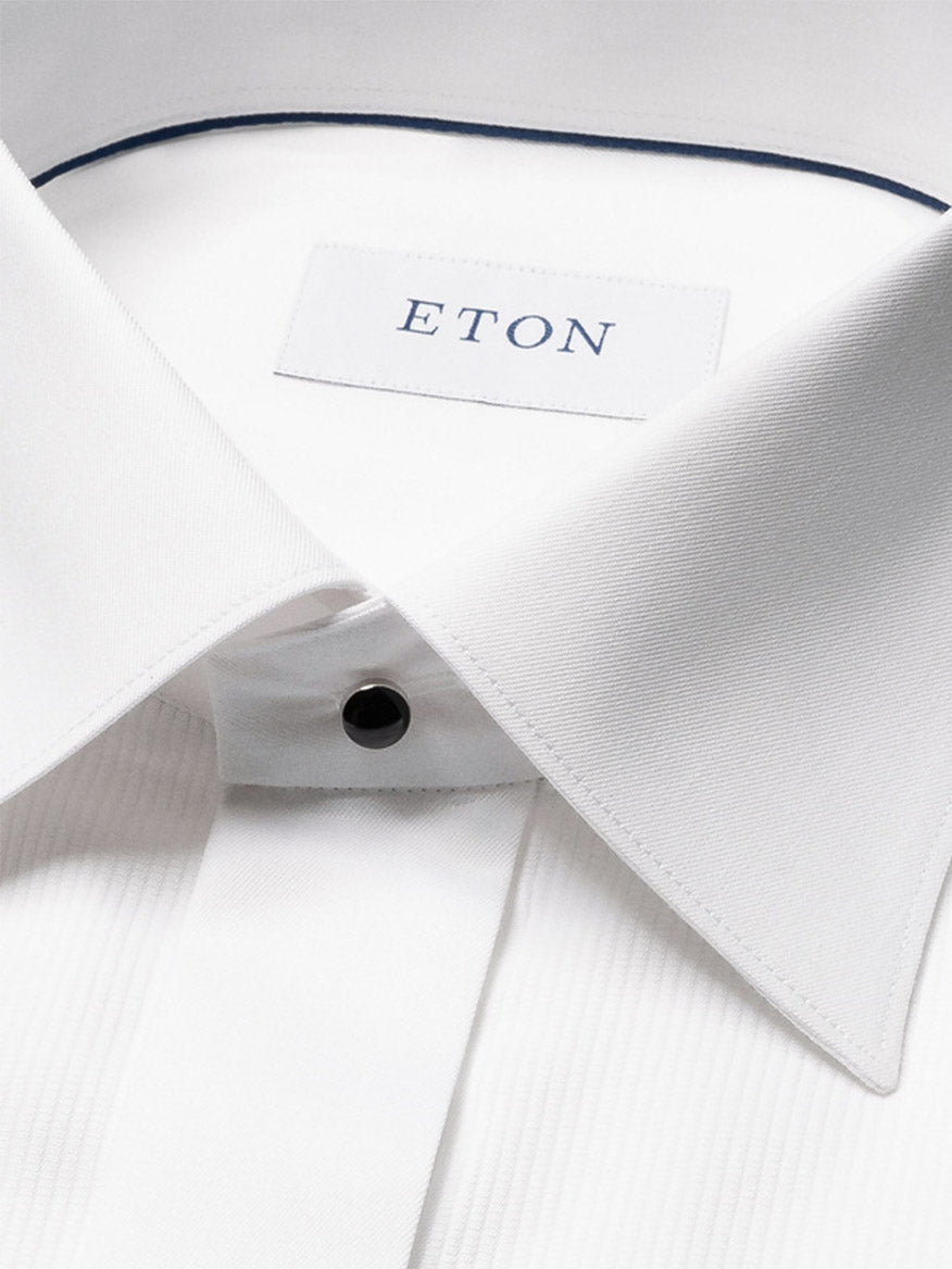 Close-up of the Eton Contemporary Fit Fine Striped Bib Evening Shirt in White, featuring a spread collar, black button, visible brand label, and refined French cuffs.