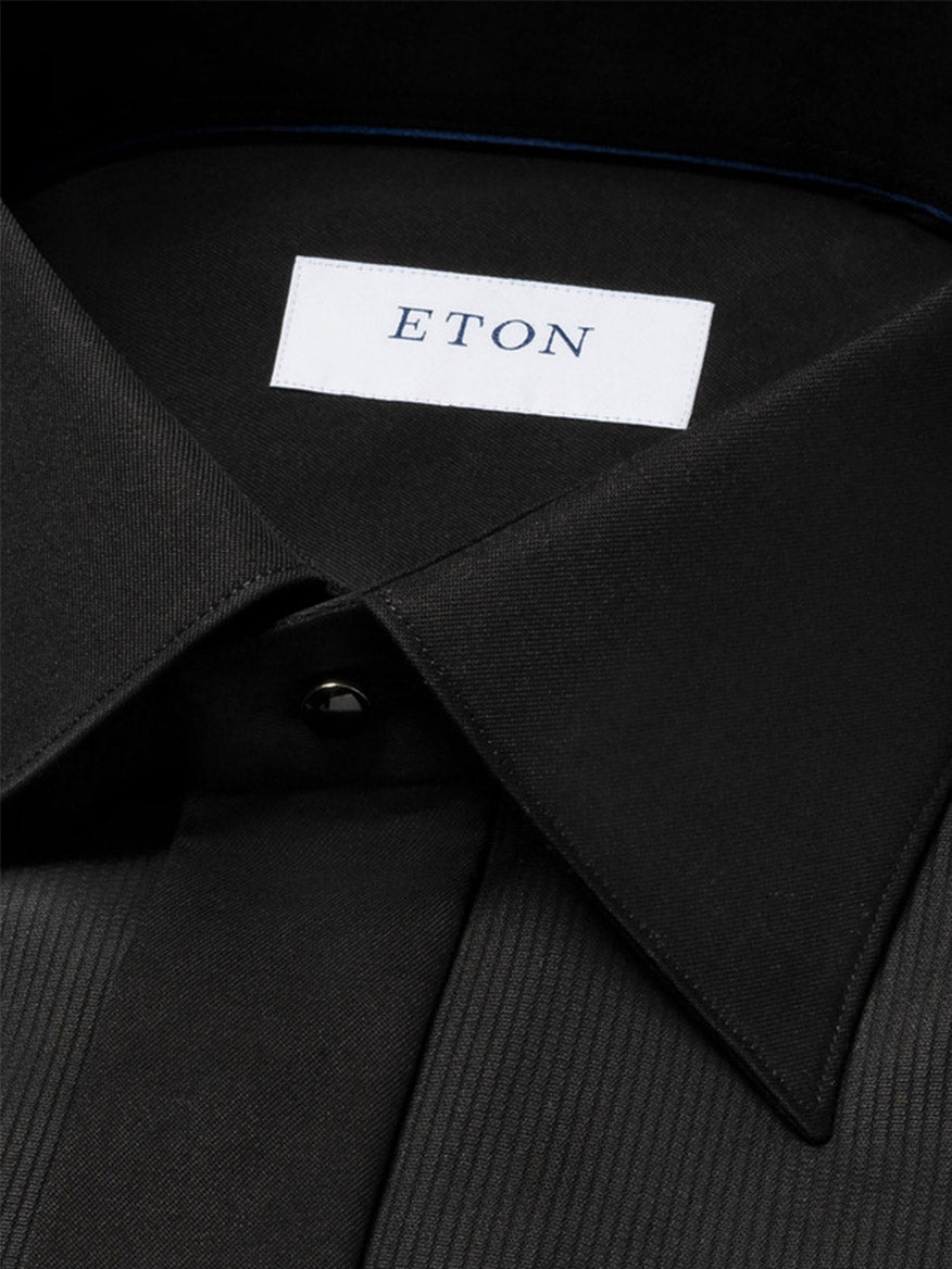 Close-up of the Eton Contemporary Fit Fine Striped Bib Evening Shirt in Black, showcasing its French cuffs and collar with an "ETON" label.