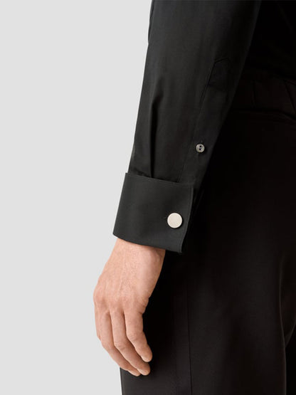 A person wearing the Eton Contemporary Fit Fine Striped Bib Evening Shirt in Black with French cuffs and a silver cufflink, shown from the side against a plain background.
