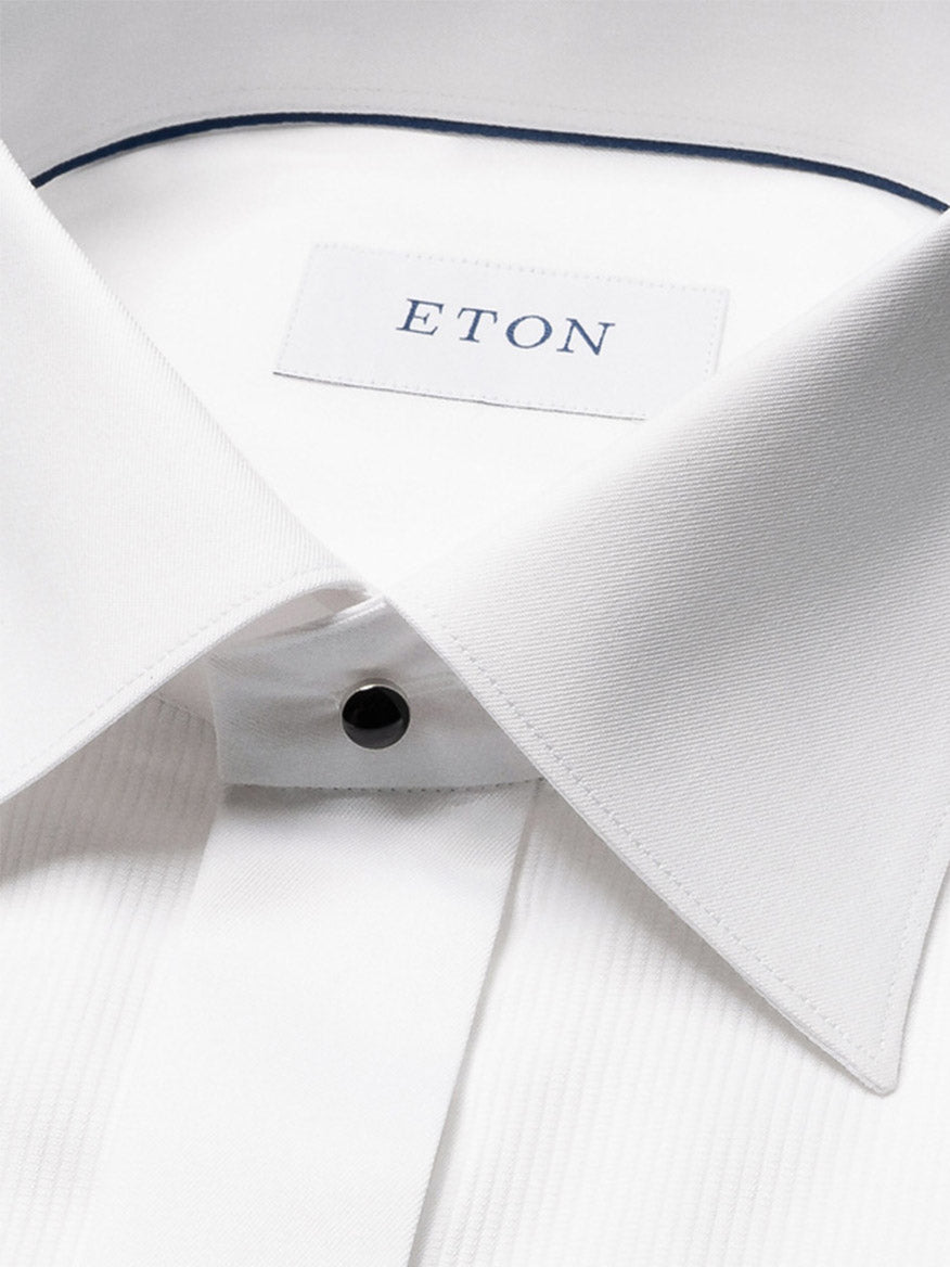 A close-up of the Eton Slim Fit Fine Striped Bib Evening Shirt in White, featuring a spread collar, French cuffs, black button, and visible brand label inside the collar.