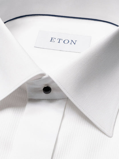 A close-up of the Eton Slim Fit Fine Striped Bib Evening Shirt in White, featuring a spread collar, French cuffs, black button, and visible brand label inside the collar.
