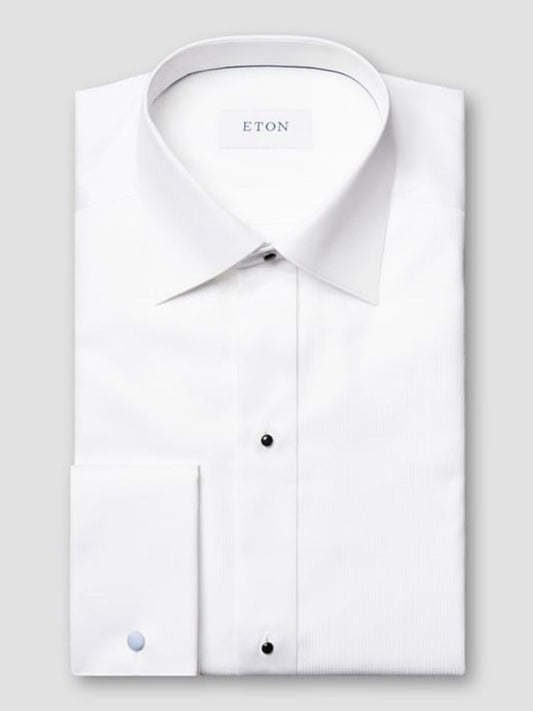 The Eton Slim Fit Fine Striped Bib Evening Shirt in White features a spread collar, French cuffs, black buttons, and a slim fit, displayed folded on a light gray background with the "ETON" label visible.