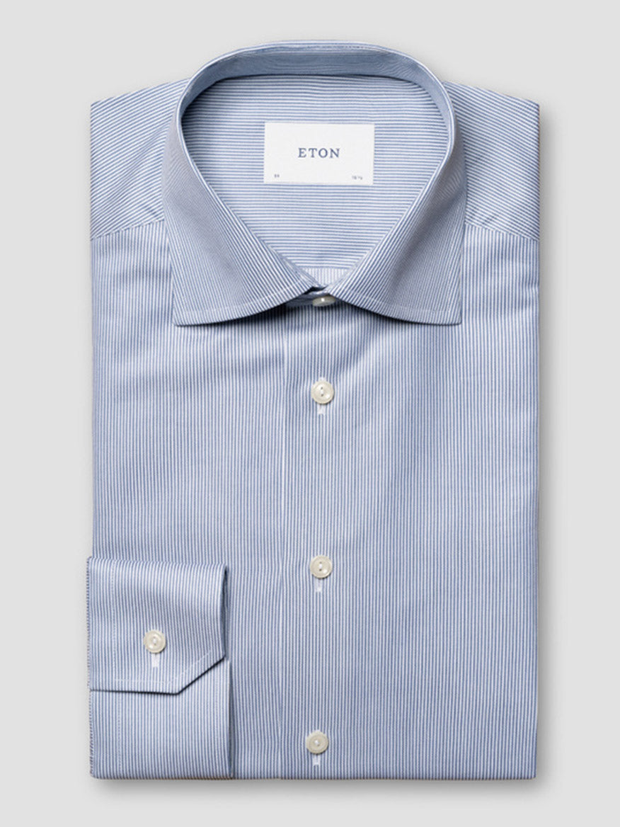 The Eton Contemporary Fit Fine Striped Signature Twill Dress Shirt in Mid Blue features white pinstripes, a spread collar, and white buttons. The "ETON" label inside the collar completes this business classic.