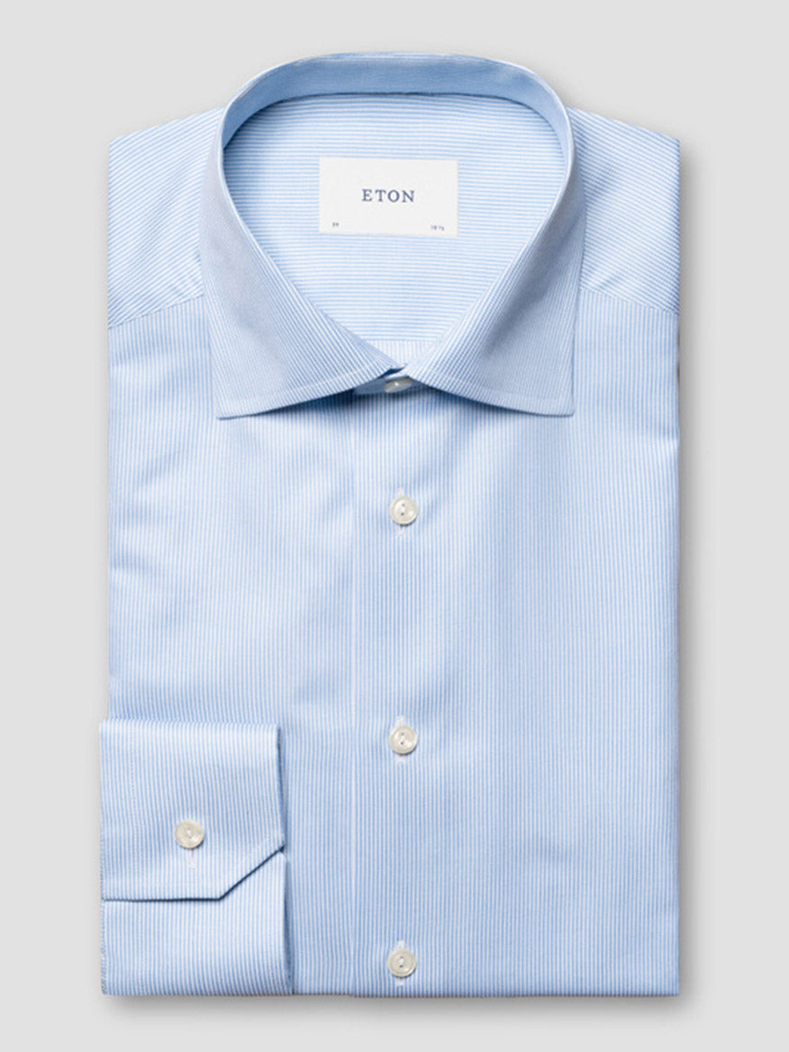 The Eton Slim Fit Fine Striped Signature Twill Dress Shirt in light blue features a cut away collar, subtle stripes, buttoned cuffs, and a visible "Eton" label on the inside collar.
