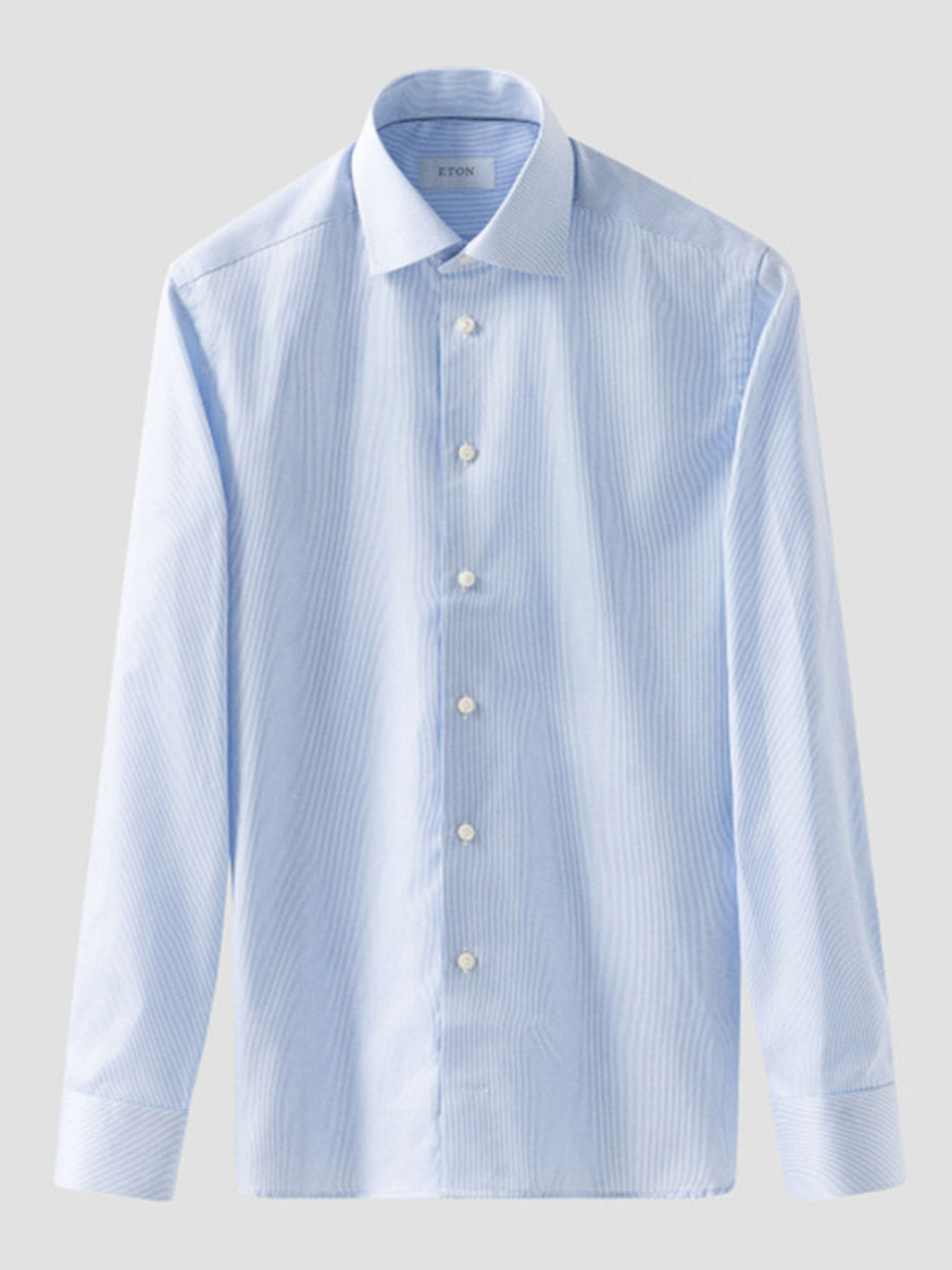 The Eton Slim Fit Fine Striped Signature Twill Dress Shirt in Light Blue features a cut away collar and subtle vertical stripes, shown on a plain background.