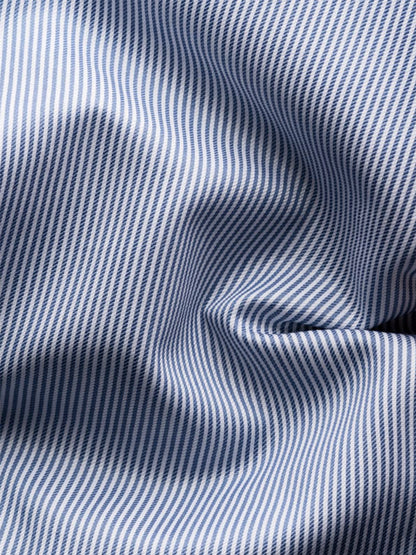 Close-up of the Eton Slim Fit Fine Striped Signature Twill Dress Shirt in Mid Blue, featuring blue and white stripes with visible folds—ideal for a timeless business look.