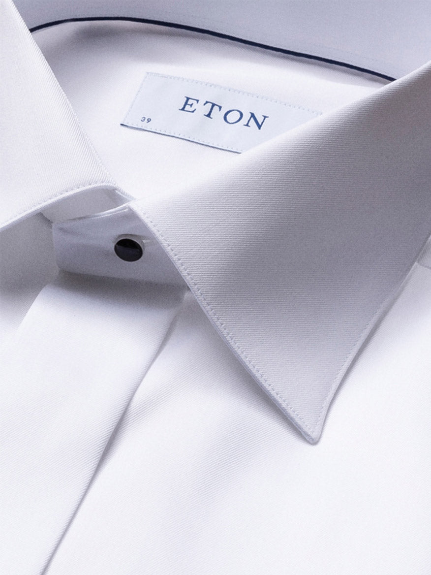 Close-up of the Eton Contemporary Fit Fly Front Signature Twill Evening Shirt in White, featuring a pointed collar, black button, French cuffs, and the ETON label inside the collar.