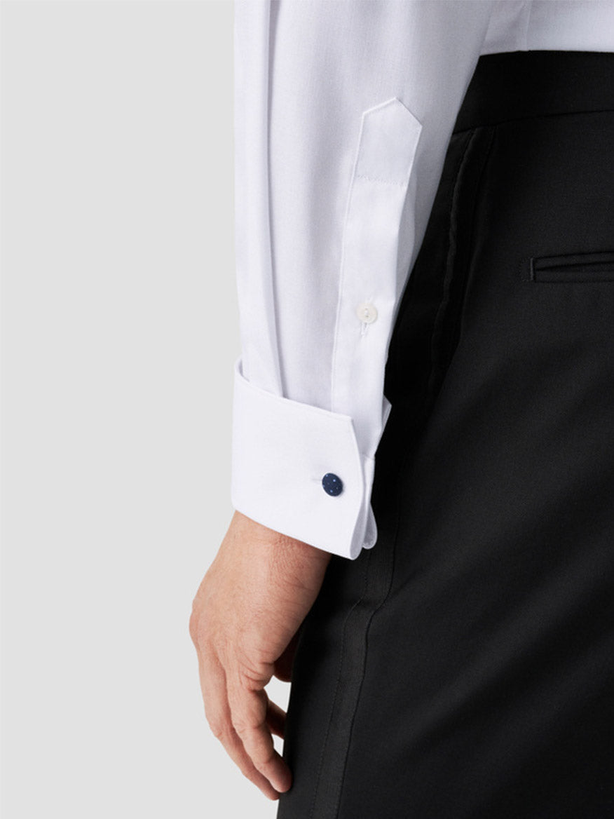 A person wears the Eton Contemporary Fit Fly Front Signature Twill Evening Shirt in white with French cuffs, dark cufflinks, and black trousers; the organic cotton shirt is neatly tucked in.