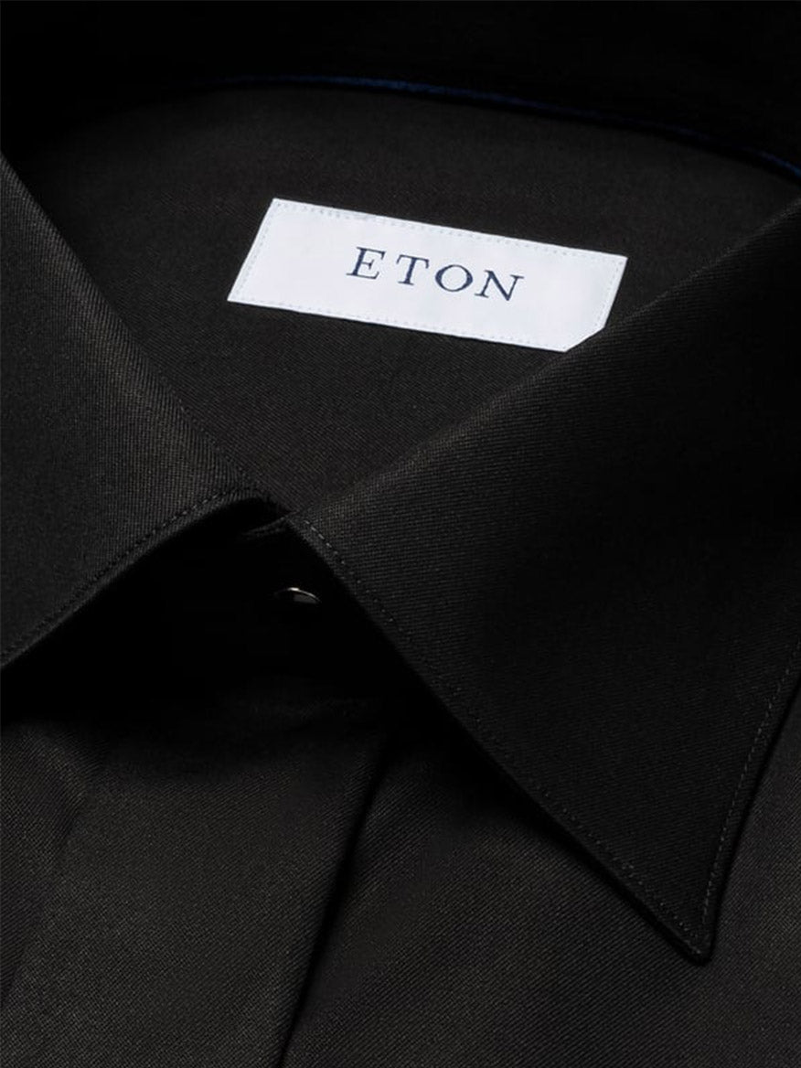 Close-up of the Eton Contemporary Fit Solid Signature Twill Dress Shirt in black with French cuffs, featuring a white "ETON" label sewn inside the collar.