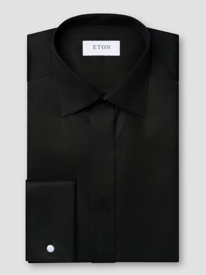 The Eton Contemporary Fit Solid Signature Twill Dress Shirt in Black with French cuffs is neatly folded and displayed against a plain gray background.