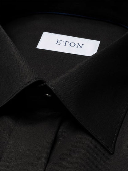 Close-up of an Eton Slim Fit Solid Signature Twill Dress Shirt in Black, showcasing the moderate cut away collar and visible white "ETON" label inside.