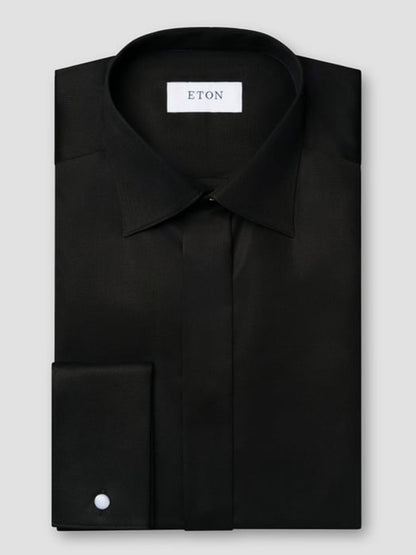 A neatly folded Eton Slim Fit Solid Signature Twill Dress Shirt in black, featuring a moderate cut away collar, concealed button placket, single cuff, and an "Eton" label inside the collar.