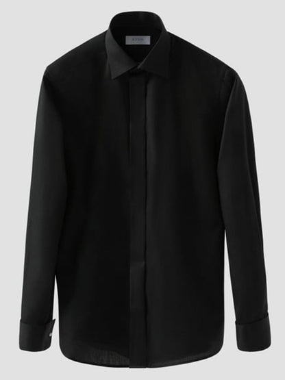 The Eton Slim Fit Solid Signature Twill Dress Shirt in Black features a moderate cut away collar and buttoned cuffs, shown against a plain grey background.