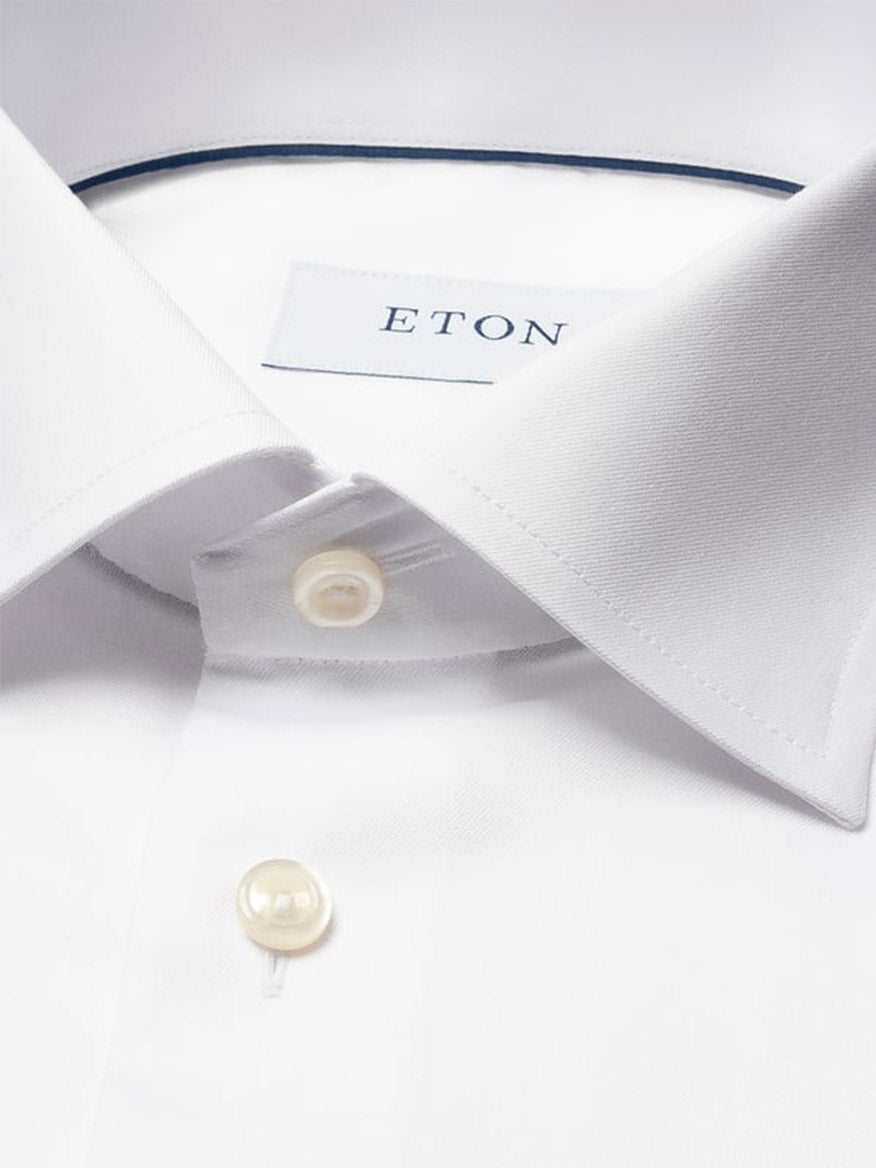 Close-up of the Eton Contemporary Fit Solid Signature Twill Dress Shirt in White, featuring a pointed collar, French cuffs, two buttons, and the Eton brand label visible inside the collar.