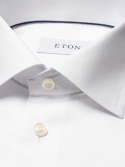 Close-up of the Eton Contemporary Fit Solid Signature Twill Dress Shirt in White, featuring a pointed collar, French cuffs, two buttons, and the Eton brand label visible inside the collar.