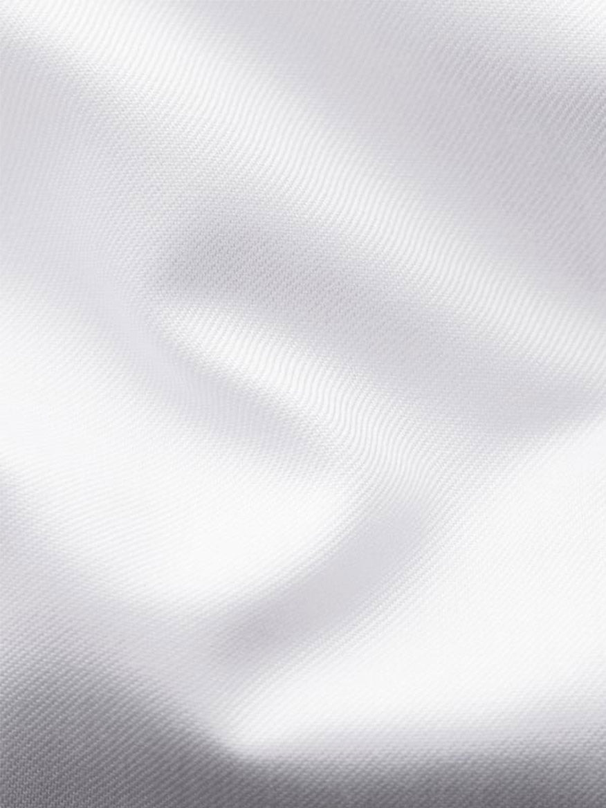 Close-up of the smooth, white signature twill fabric from the Eton Contemporary Fit Solid Signature Twill Dress Shirt in White - French Cuff, with soft folds and subtle shadows highlighting its luxurious organic cotton texture.