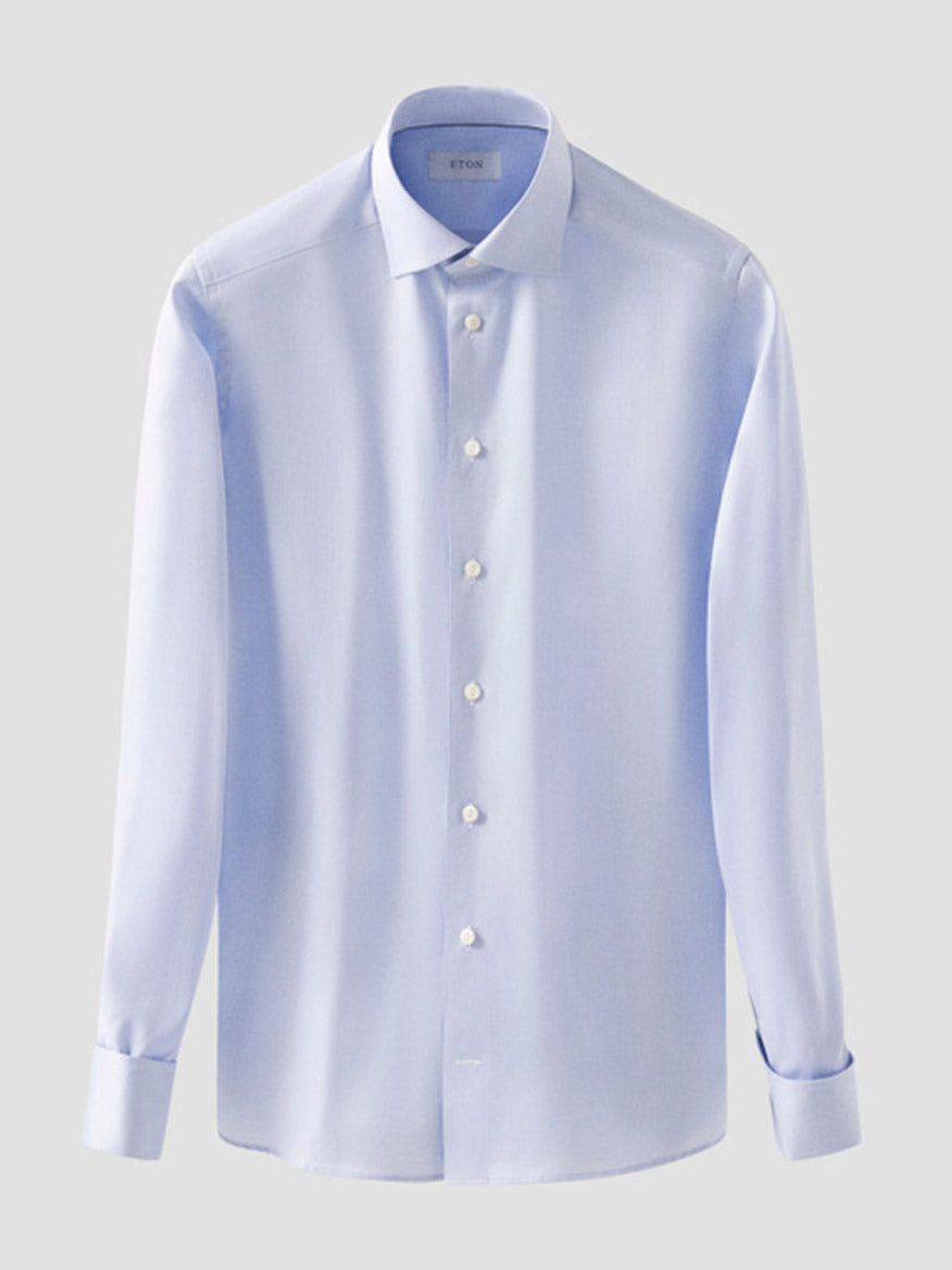 The Eton Contemporary Fit Solid Signature Twill Dress Shirt in light blue features French cuffs and is displayed on a plain grey background.