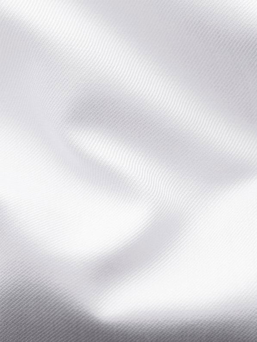 Close-up of the Eton Slim Fit Solid Signature Twill Dress Shirt in White—French Cuff, showing its smooth, wavy organic cotton twill texture with subtle light and shadow variations.